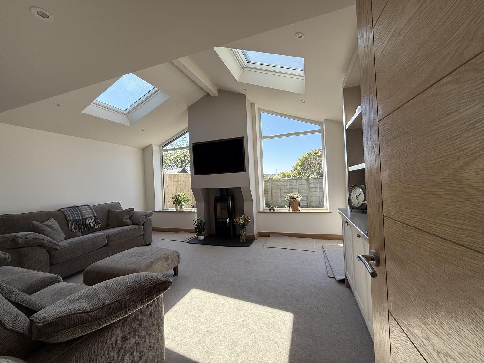 Vaulted living room extension with rooflights and a log burner