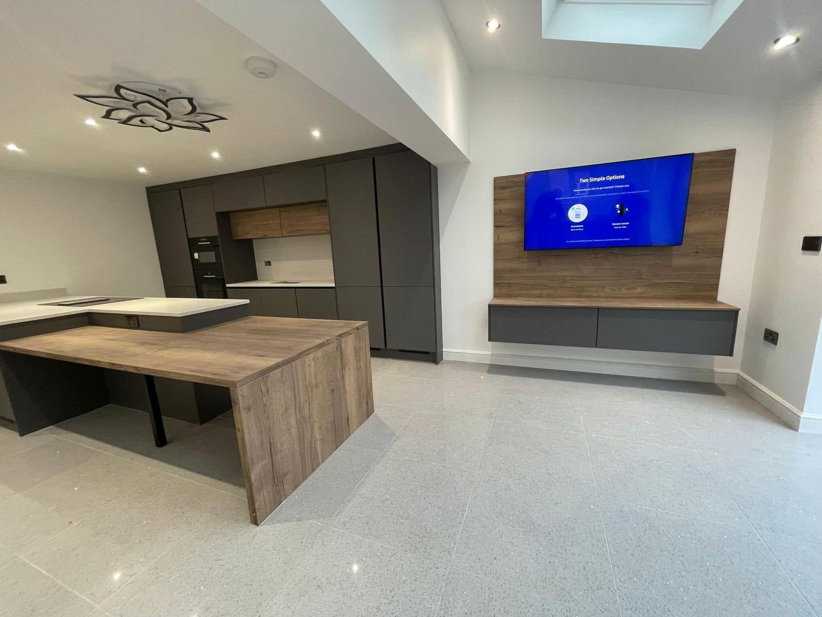 Kitchen with handleless units, oak island and media wall
